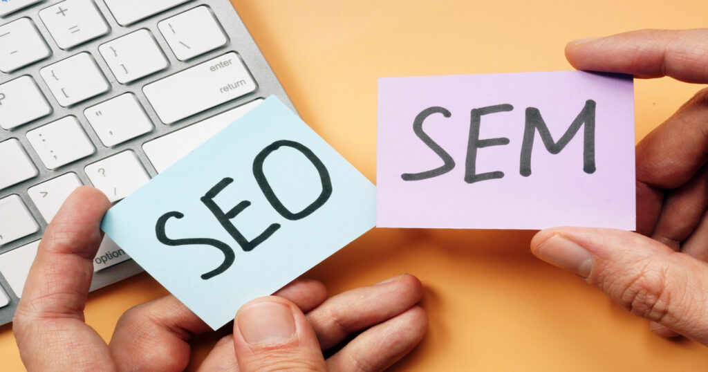 person hand showing cards indicates topic about differences between SEO vs SEM