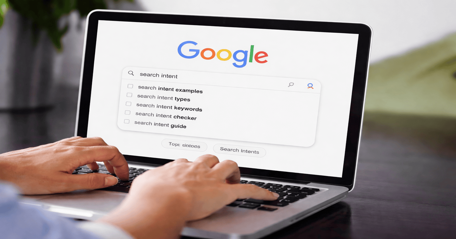 A user typing “search intent” into Google on a laptop, showing search suggestions on the screen